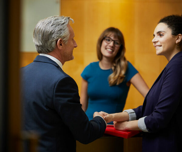 Group of young serious medical workers gathered to discuss chest x-ray of patient with suspected coronavirus