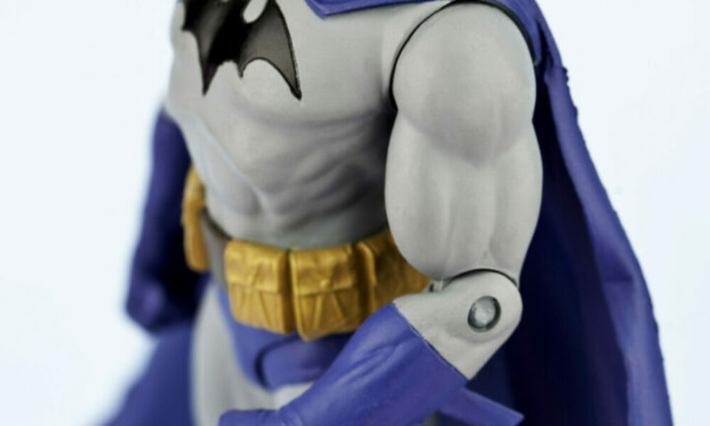 "Suffolk, Virginia, USA - May 22, 2011: A vertical studio shot of the DC Comics Superhero comic book character Batman, also known as the Caped Crusader. Here Batman is standing sideways with his head tilted up, facing the camera. This figurine is made by DC Direct/DC Comics."